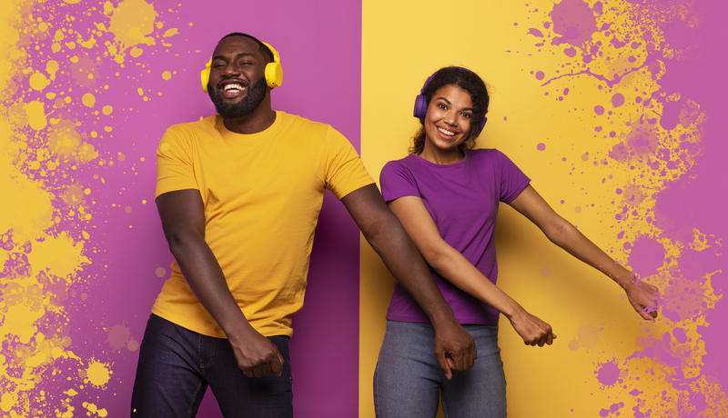 Couple with headset listen to music and dance with energy on violet and yellow background
